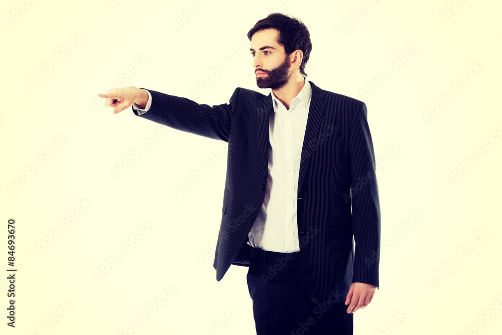 Happy businessman points his finger. Happy businessman points his finger.