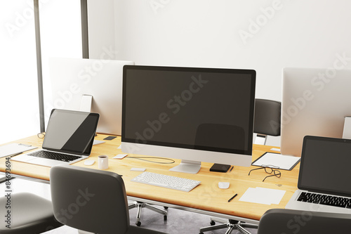 Wooden conference table with office accessories and computers