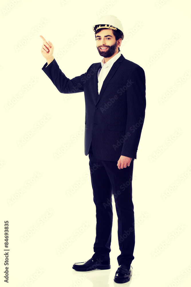 Engineer in protective helmet pointing up. Engineer in protective helmet pointing up.