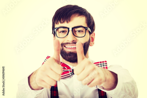 Man wearing suspenders with thumbs up.