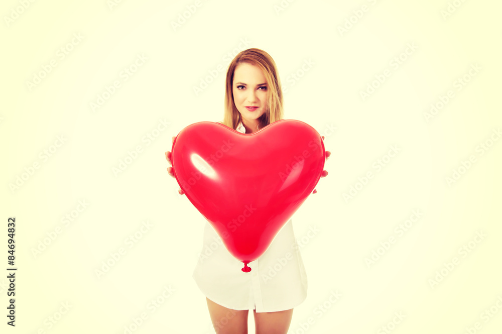 Young woman with heart shaped balloon. Young woman with heart shaped balloon.