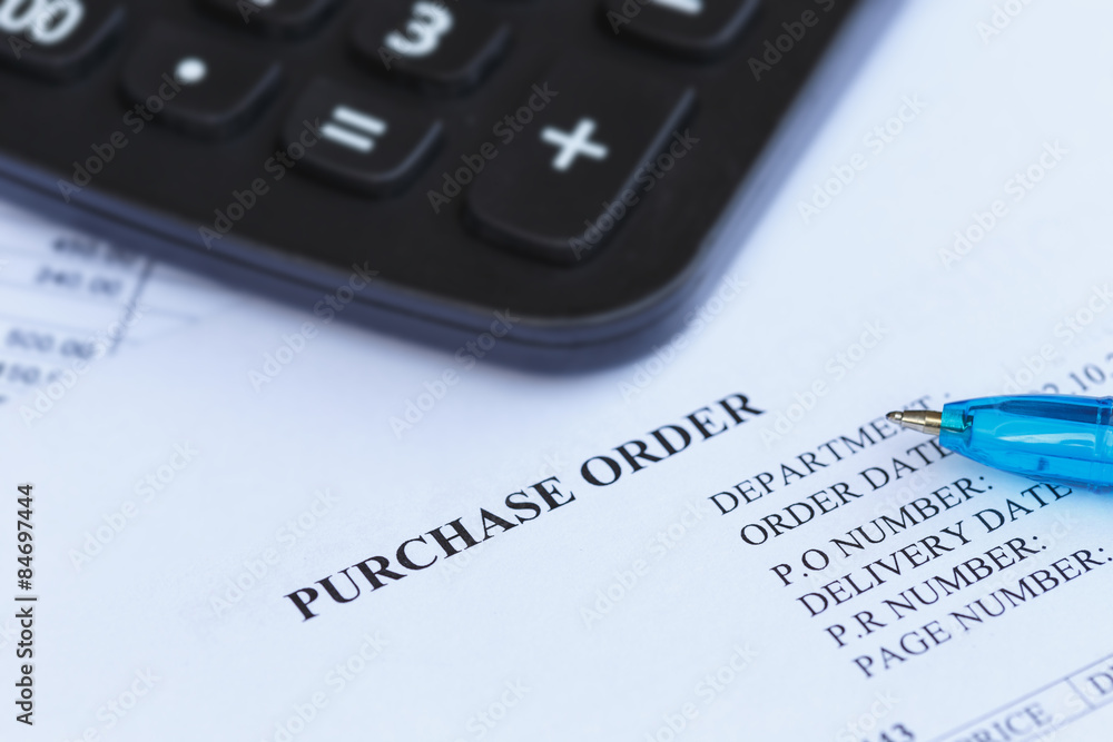 purchase order with pen and calculator in the office purchase order with pen and calculator in the office