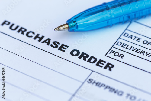 purchase order with blue pen in the office‏