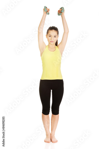 Active woman holding weights.