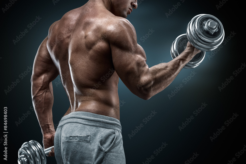 Closeup portrait of a muscular man workout with barbell at gym Closeup portrait of a muscular man workout with barbell at gym