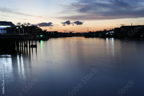 River to the Sea in Fisherman village with silhouette Sunset © bignai