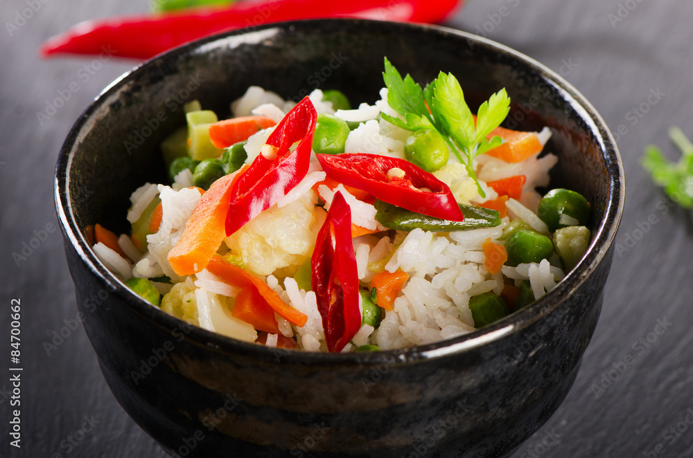 Rice and vegetables on a black table. Rice and vegetables on a black table.