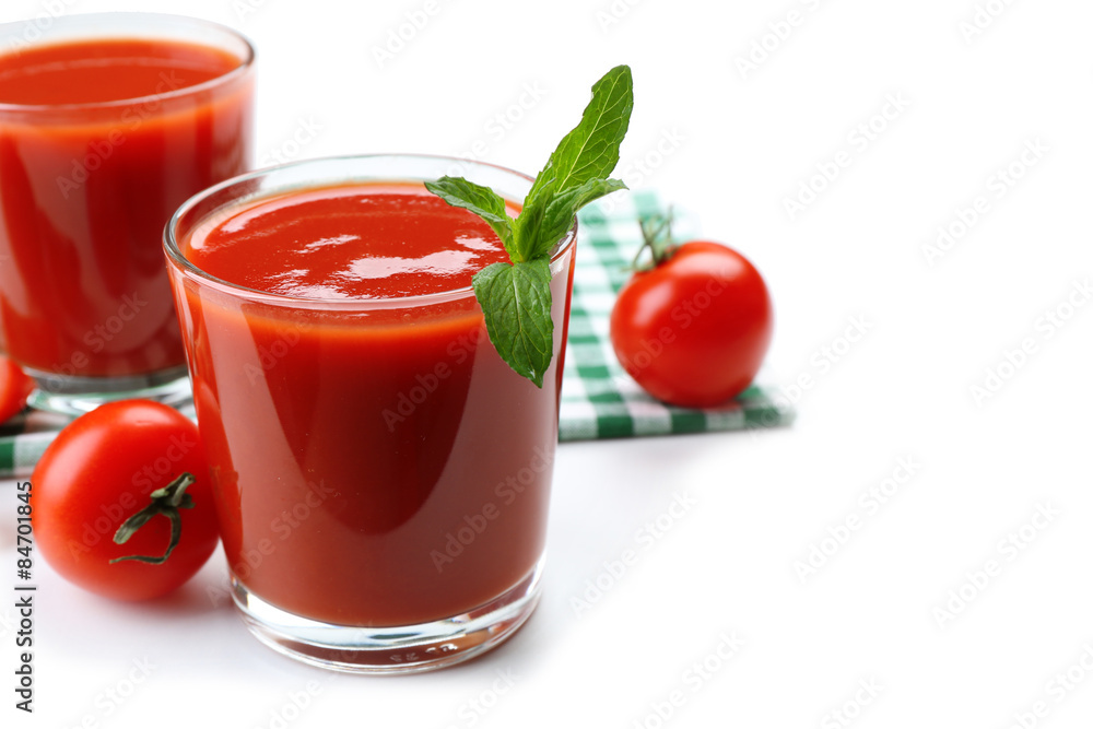 Glasses of fresh tomato juice on checkered napkin, isolated on white Glasses of fresh tomato juice on checkered napkin, isolated on white