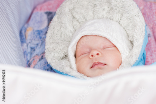 newborn baby sleeping in a stroller