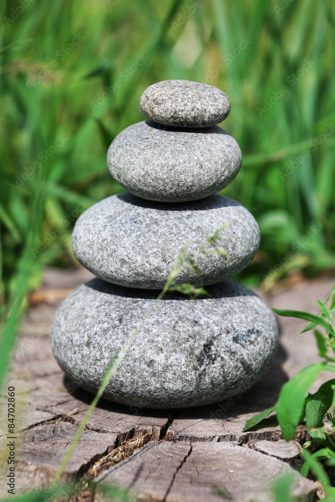 Stack of spa stones over green grass background Stack of spa stones over green grass background