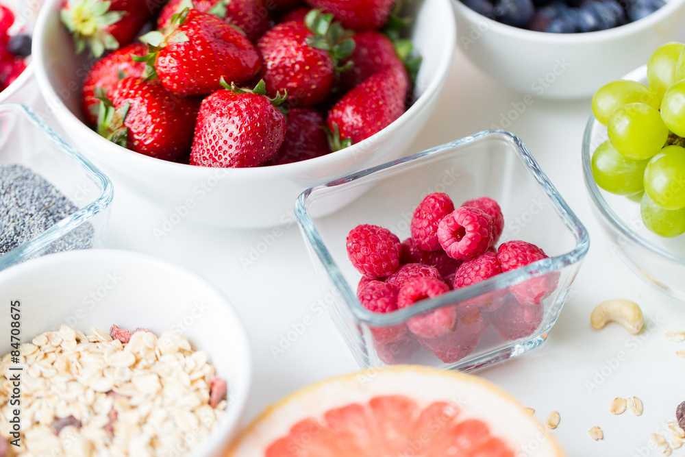 close up of fruits and berries in bowl on table close up of fruits and berries in bowl on table
