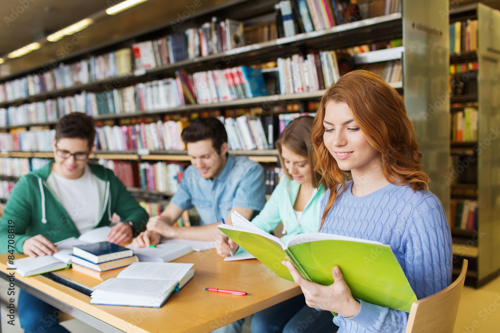 happy students reading books in library happy students reading books in library