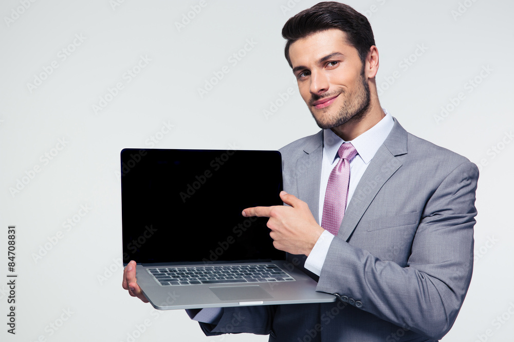 Businessman pointing finger on the laptop screen Businessman pointing finger on the laptop screen