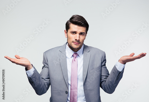 Businessman shrugging shoulders photo