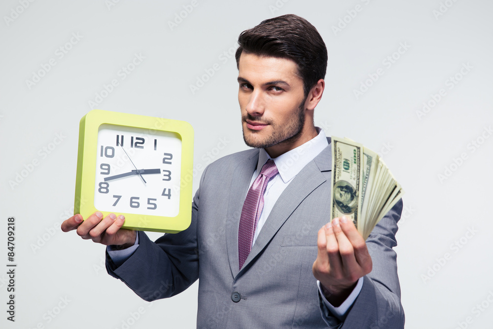 Businessman holding money and clock Businessman holding money and clock