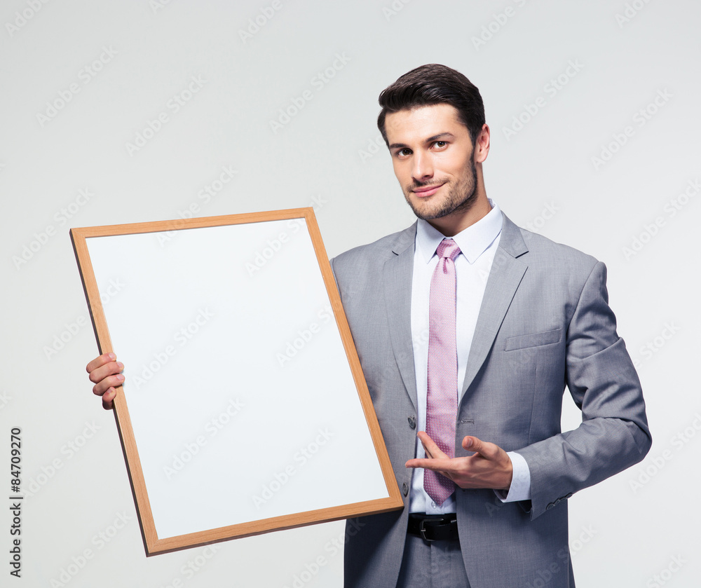 Happy businessman presenting blank board Happy businessman presenting blank board