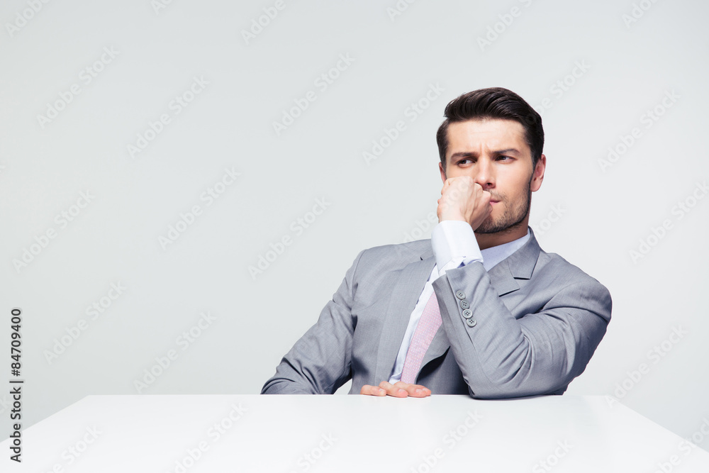 Thoughtful businessman sitting at the table Thoughtful businessman sitting at the table