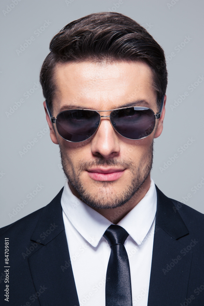 Businessman in sunglasses looking at camera Businessman in sunglasses looking at camera