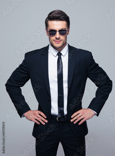 Young serious businessman in sunglasses