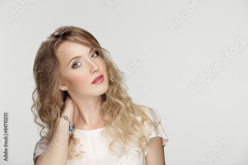 Portrait of perfect curvy young blond girl with makeup and retou