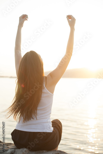 Relaxation on the water outdoors, woman with hands up © Markomarcello