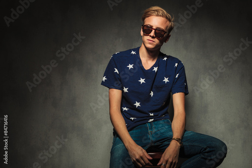 blond fashion model with glasses sitting on a chair © Viorel Sima