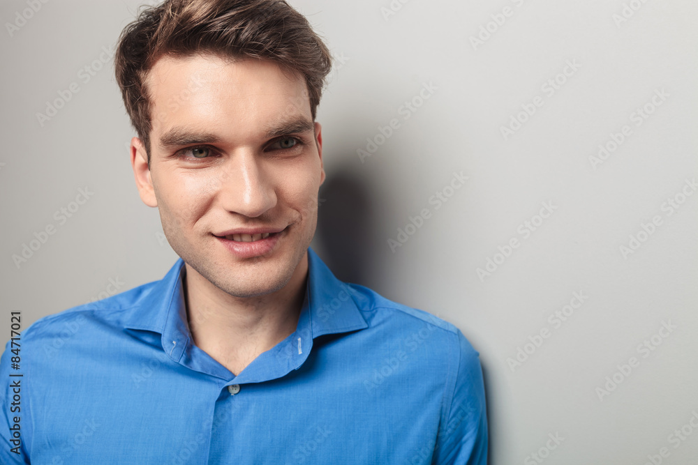 young man smiling away from the camera. young man smiling away from the camera.