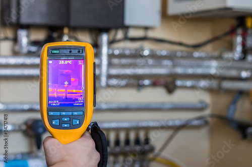 Thermal imaging inspection of heat system with tubes at house