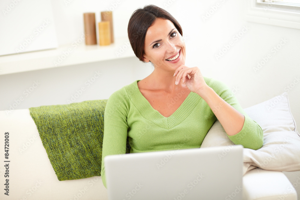 Caucasian woman holding a laptop indoors Caucasian woman holding a laptop indoors