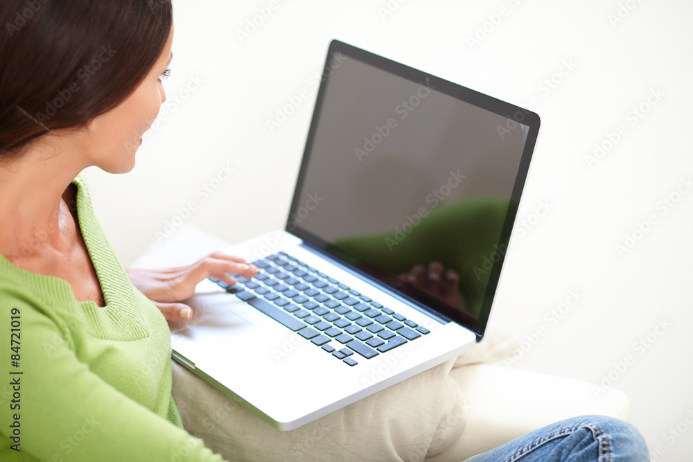 Relaxed caucasian woman using a laptop Relaxed caucasian woman using a laptop