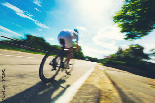 Fototapeta Naklejka Na Ścianę i Meble -  Cyclist speeding during a competition in summer