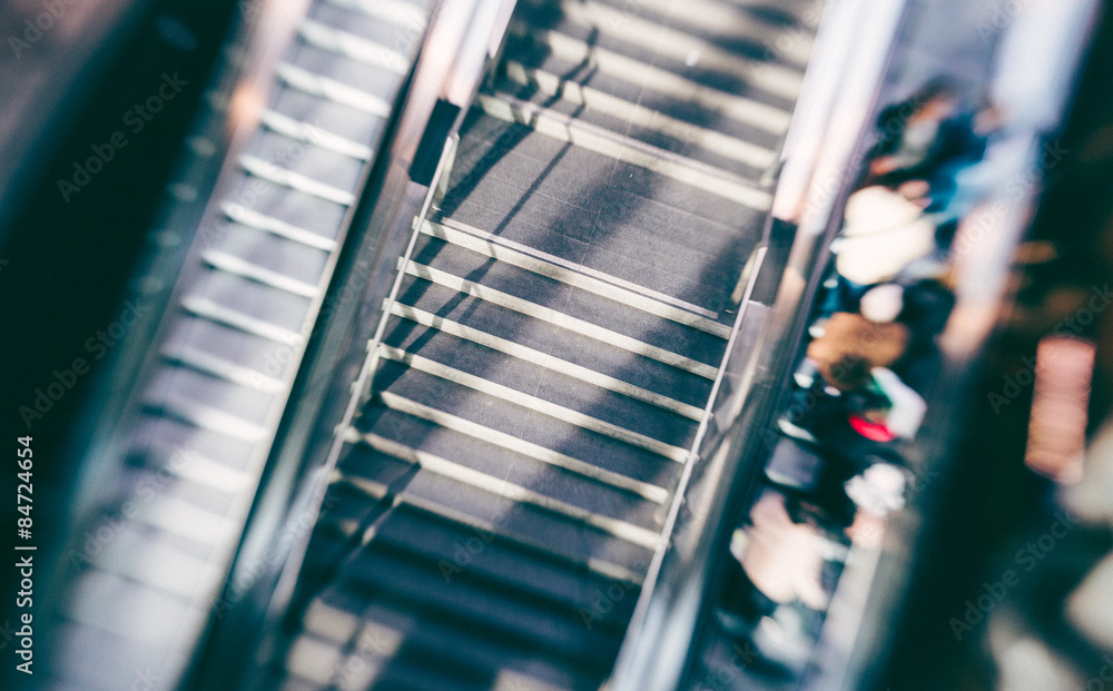 People on an escalator People on an escalator