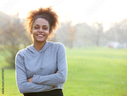 Friendly young woman standing outside