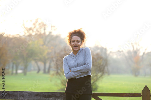 Healthy young woman standing in nature smiling © mimagephotos