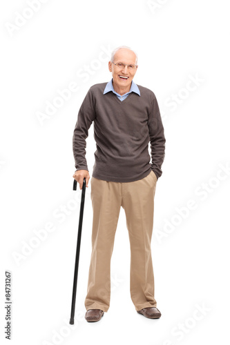 Senior man with a cane smiling and posing