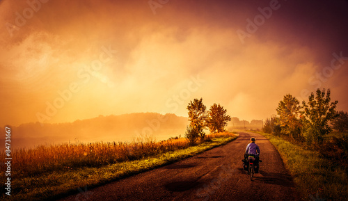 Woman cycling alone on the narrow rural roads in Poland © Pav-Pro Photography 
