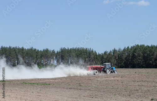 The tractor is spraying fertilizer in a field © Timmary