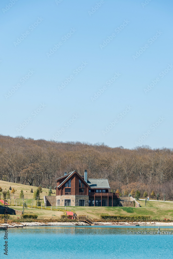 Modern house near water on bright day Modern house near water on bright day