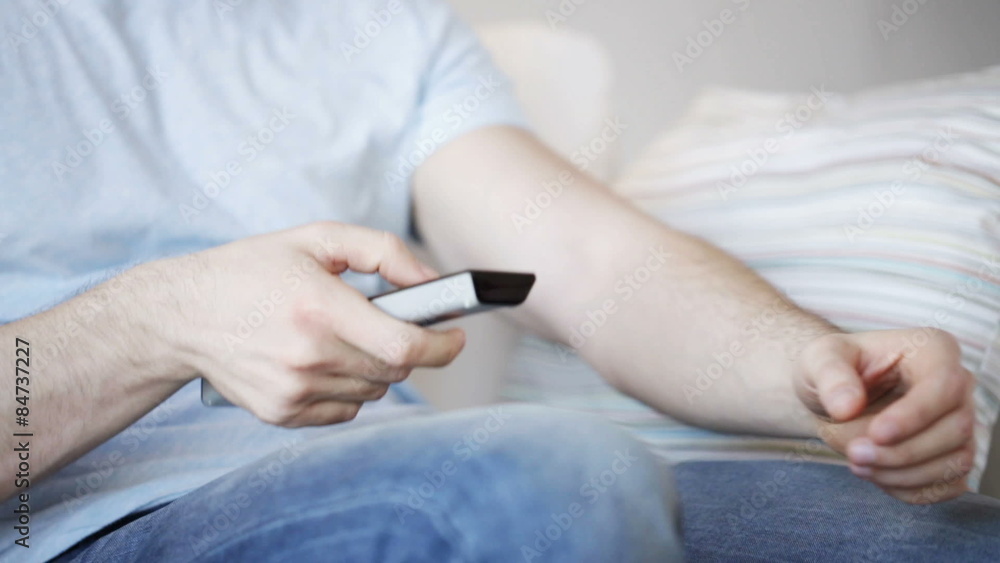 close up of man with beer and remote at home close up of man with beer and remote at home