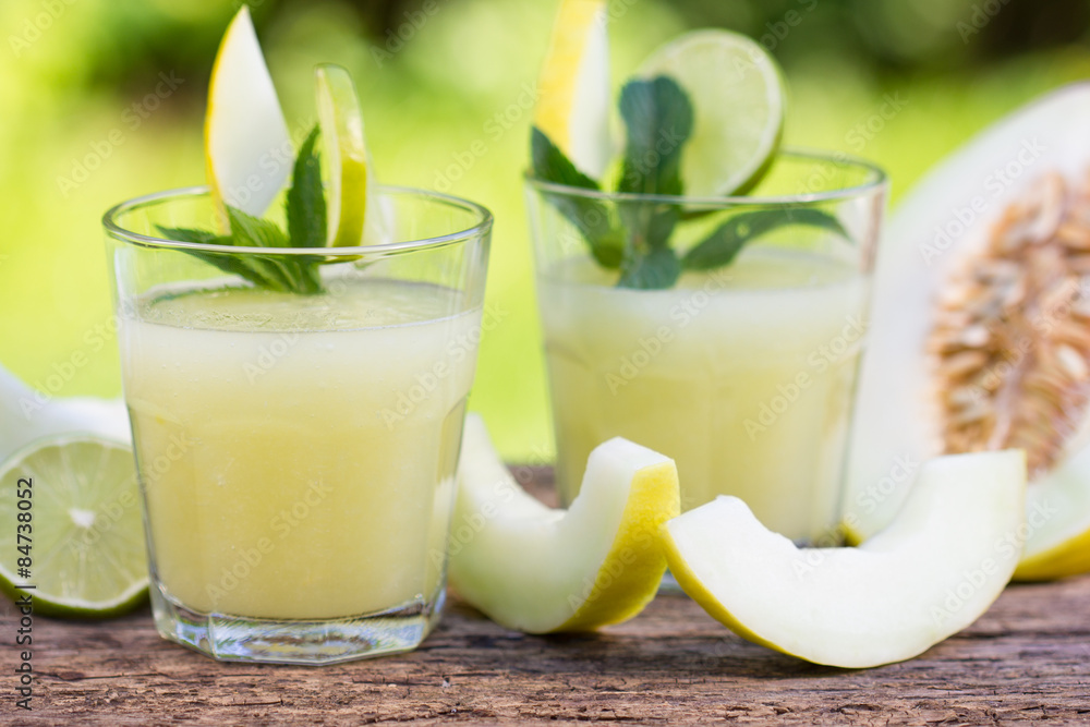 Two glsses of melon juice on the wooden table Two glsses of melon juice on the wooden table