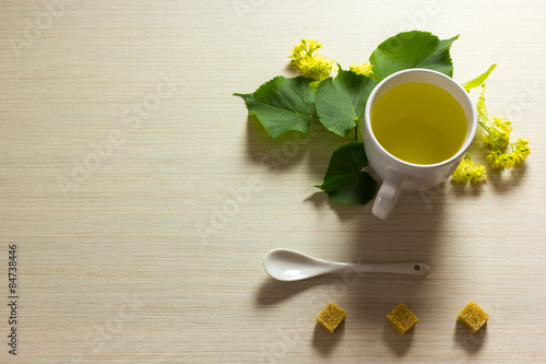 Linden tea cup with linden flowers on textured background