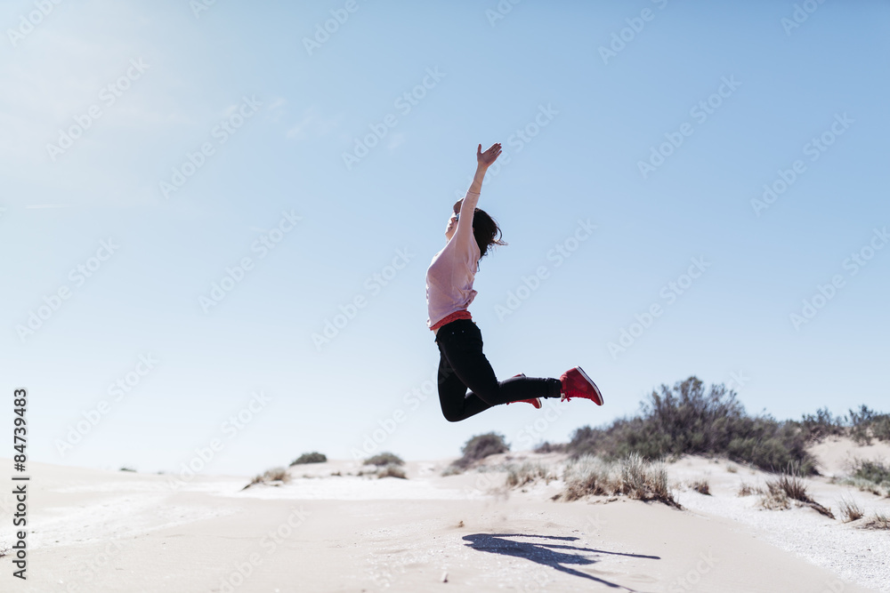 Happy woman jumping on big beach. Beautiful day of spring Happy woman jumping on big beach. Beautiful day of spring