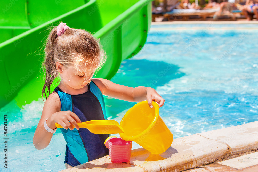 Child with bucket in swimming pool. Child with bucket in swimming pool.