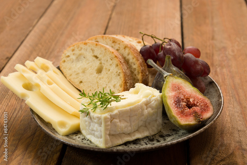 snack of swiss and french cheese with figs and grapes photo