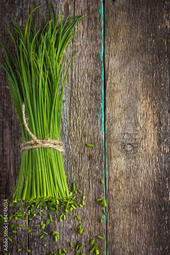 bunch of  chives on a wooden cutting board