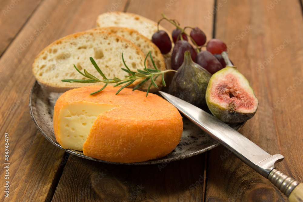 snack of french cheese with figs and grapes