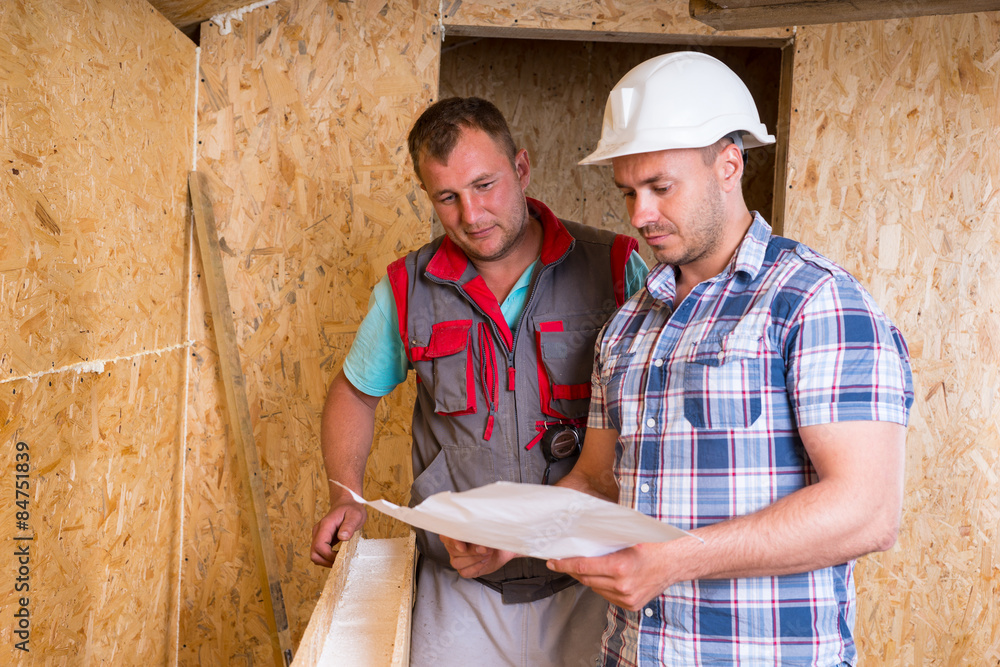 Construction Workers Consulting Plans in New Home