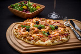 Tuna pizza with shrimp and salad, cutlery