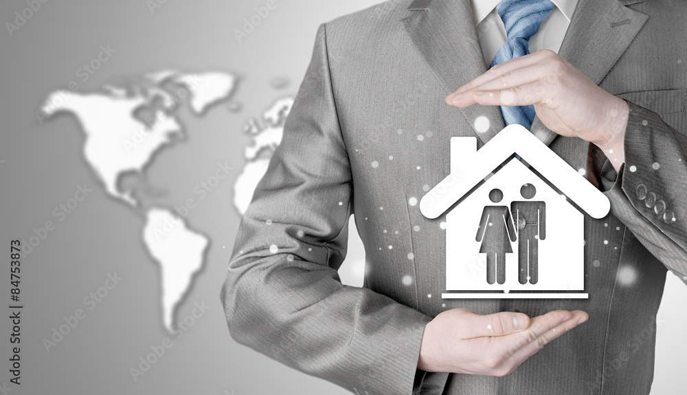 businessman protecting family in home with hands businessman protecting family in home with hands
