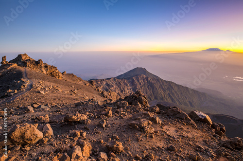 Sunrise on Mount Meru with Mt Kilimanjaro in the distance, near Arusha in Tanzania. Africa.